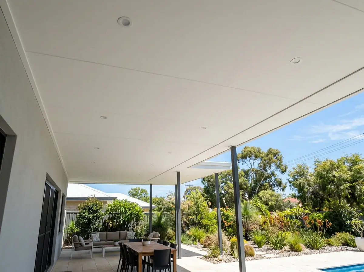 An insulated panel flat patio seen from underneath, the smooth white ceiling filling the view with downlights set flush into it and no beams hanging below